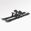 Pair of black skis with snowboardi bindings on a white background