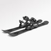 Pair of black skis with snowboardi bindings on a white background
