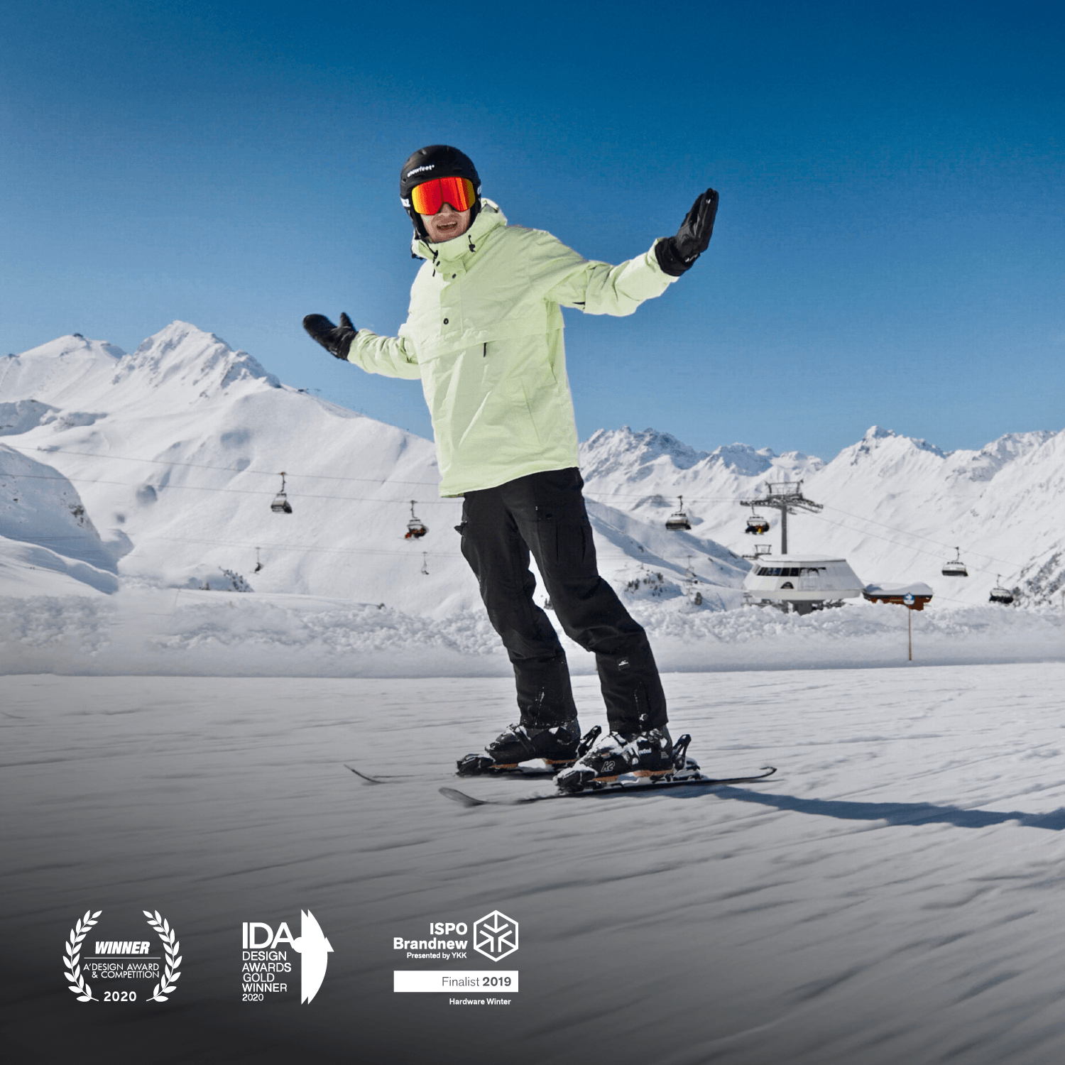 Person skiing with short skis on a snowy slope with mountains and ski lifts in the background