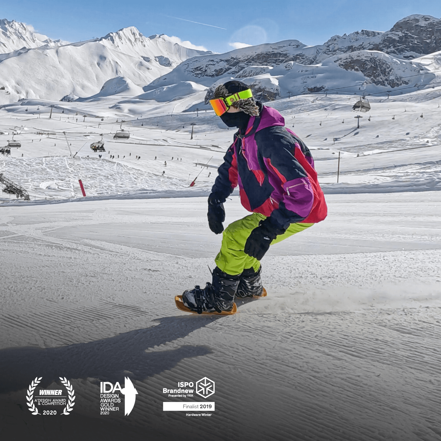 Person on short skis snowboarding on a snowy slope with mountains in the background
