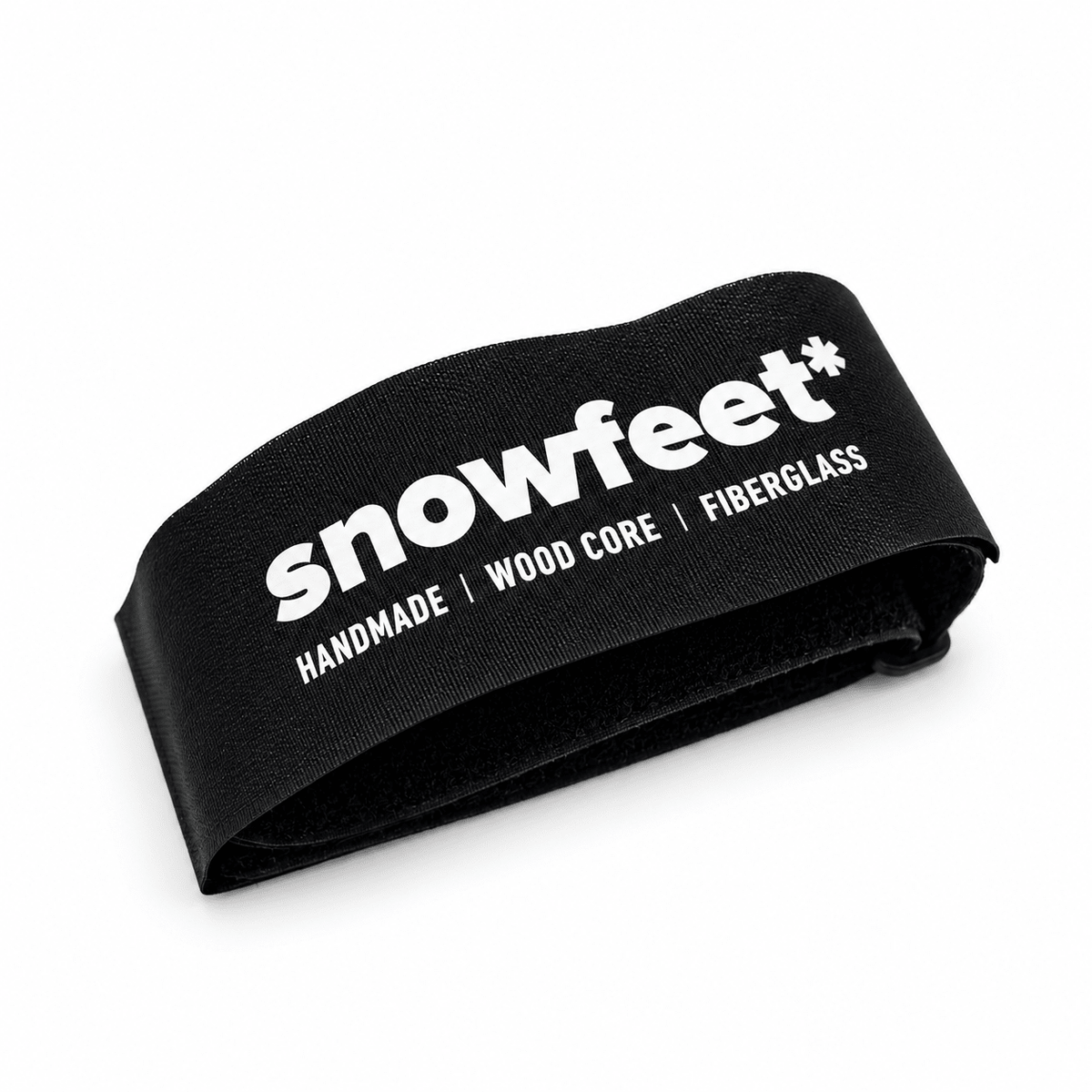 A black Snowfeet snowboard binding strap with white printed text reading 'snowfeet*' and 'HANDMADE | WOOD CORE | FIBERGLASS' on a clean white background.