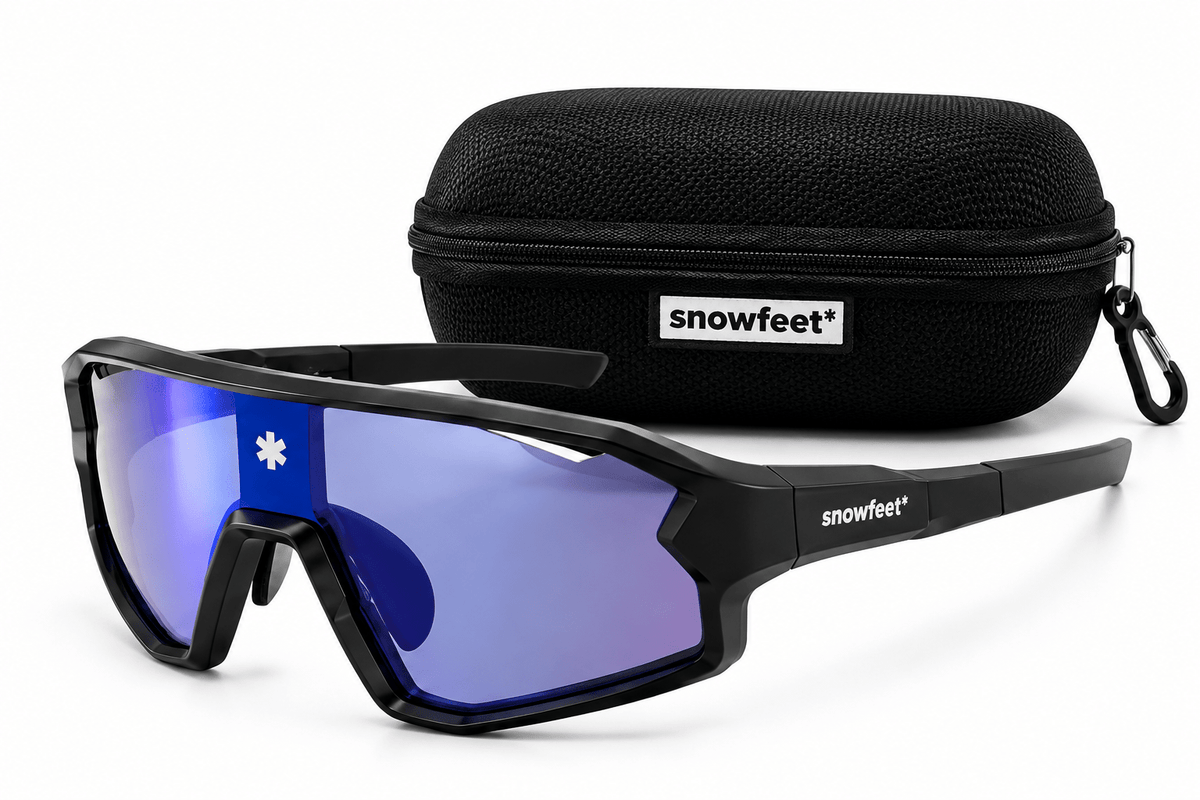 Black snowboard sunglasses with blue mirrored lenses and a black zippered protective case, both branded with the snowfeet logo, on a white background.
